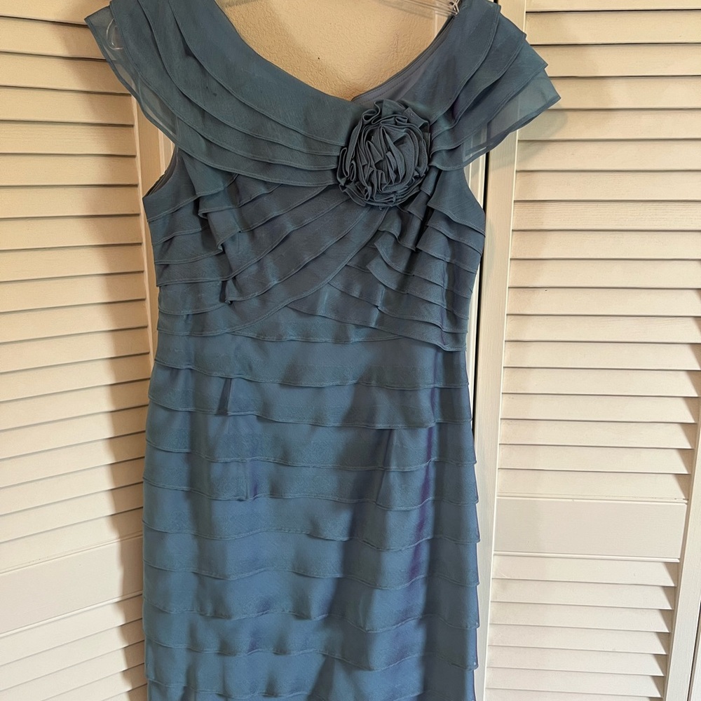 Coattail dress with iridescent purple on blue background